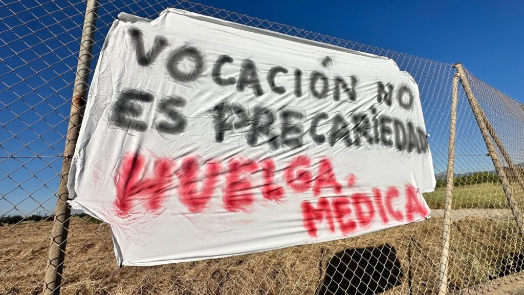 Pancarta colgada en una valla con el mensaje “Vocación no es precariedad. Huelga médica” durante la protesta de médicos en Menorca.