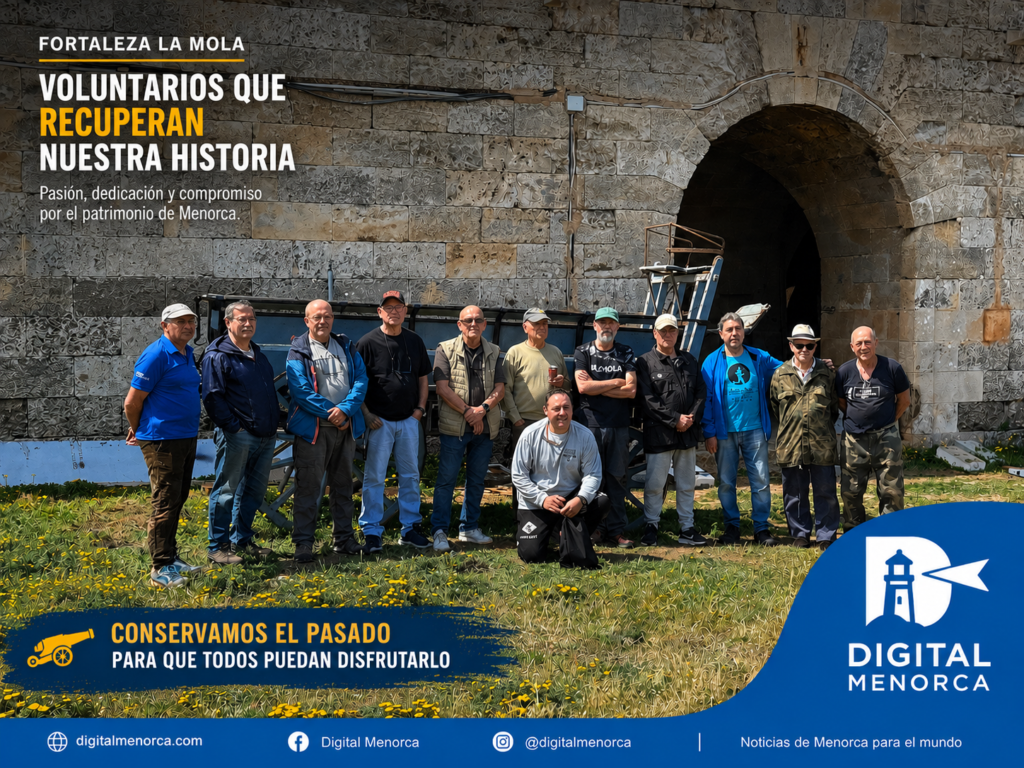 Grupo de voluntarios de La Mola posando frente a la fortaleza durante los trabajos de recuperación y conservación del patrimonio militar en Menorca.