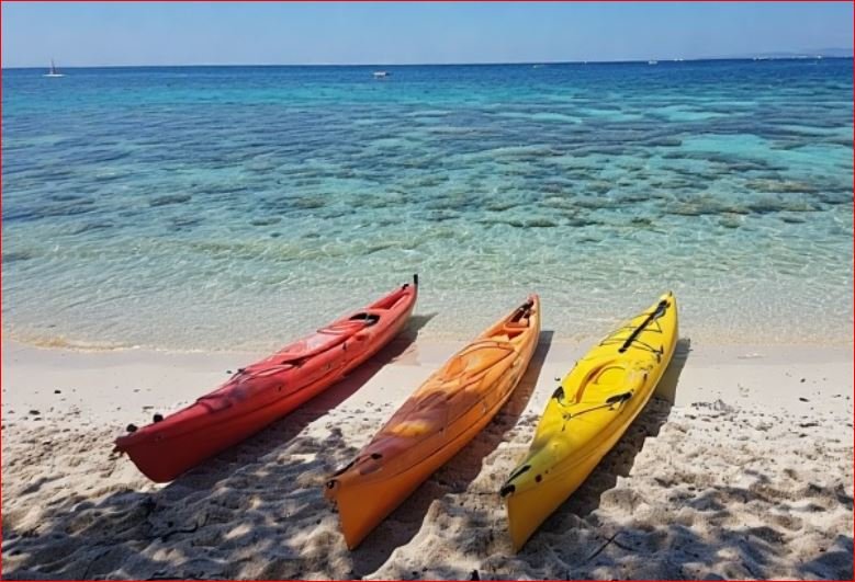 imagen de 3 kayacs en una playa de menorca